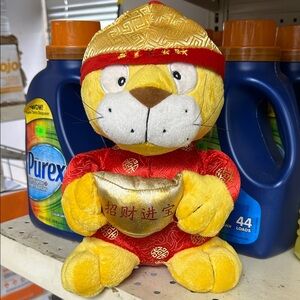 Preowned Golden Plush Tiger holding a gold-colored ingot.